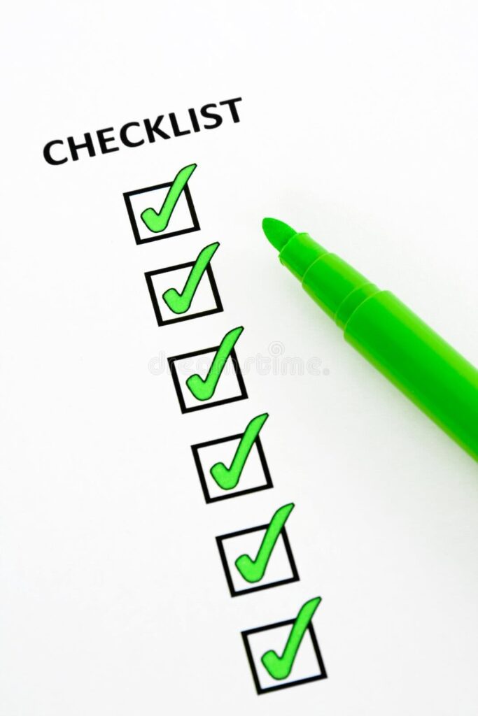 Checklist with green check marks and green marker pen on white paper
