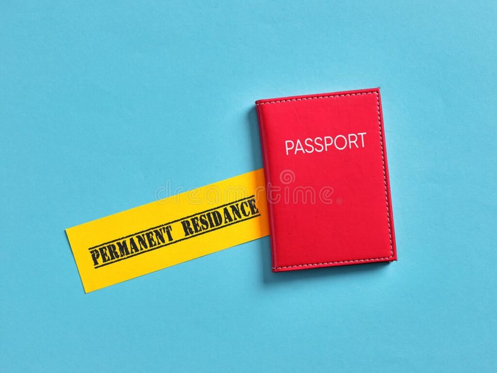 Red passport with a yellow slip labeled Permanent Residence on a blue background, symbolizing immigration or PR approval.