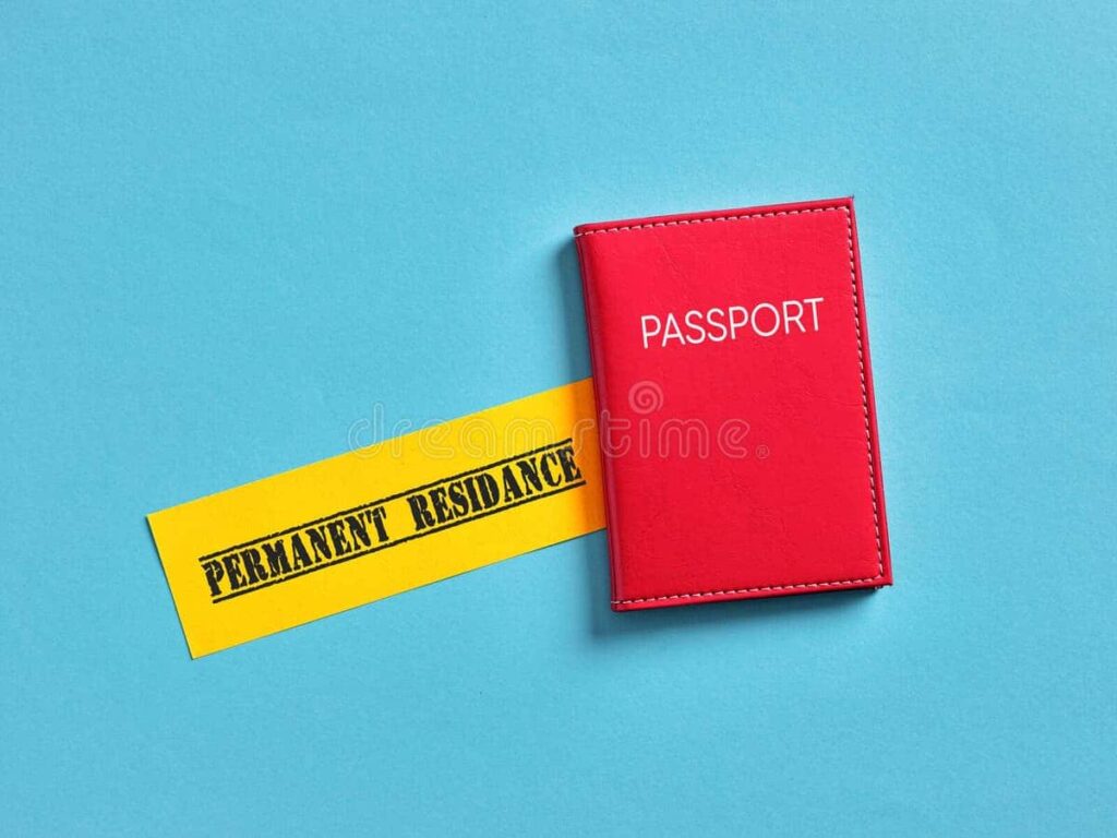 Red passport placed beside a yellow strip with the words โPermanent Residenceโ on a blue background.
