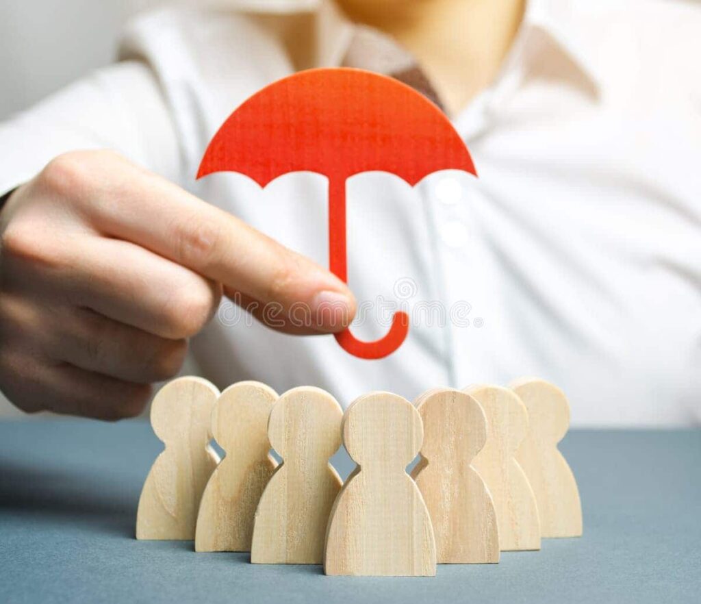 Hand holding a red umbrella over wooden human figures โ symbolizing safety and support for students in Ireland.