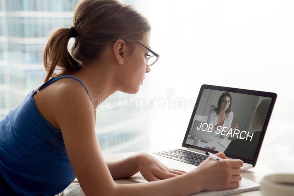 Young female student searching for part-time job opportunities in Ireland on a laptop