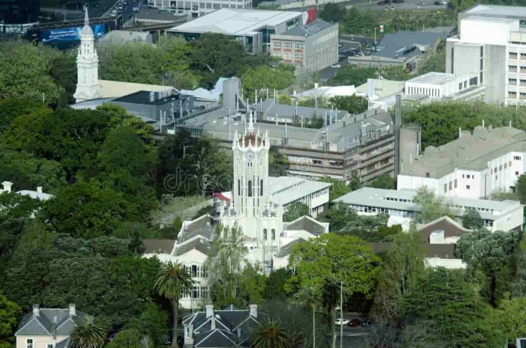 Aerial view of the University of Auckland campus featuring the historic ClockTower surrounded by greenery and modern buildings.