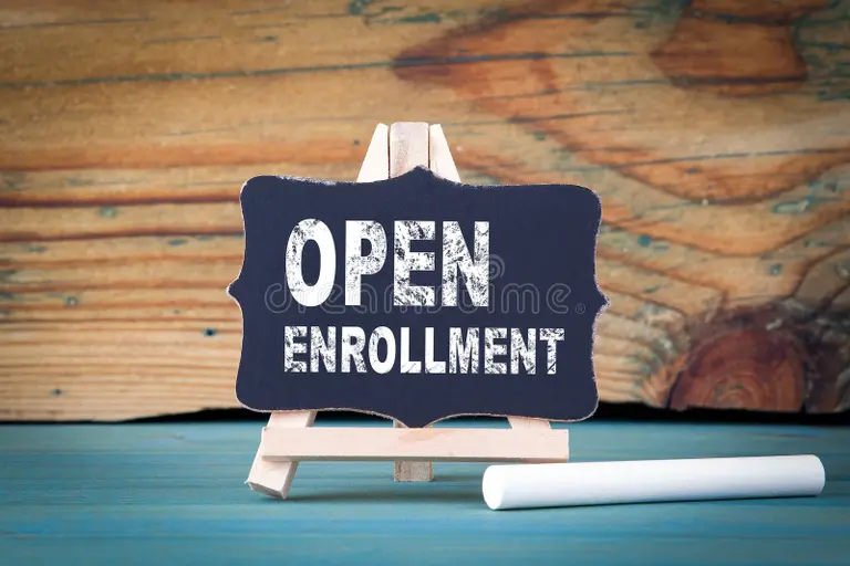 Chalkboard sign reading “Open Enrollment” with a chalk stick—application timeline and deadlines for Study in Singapore.
