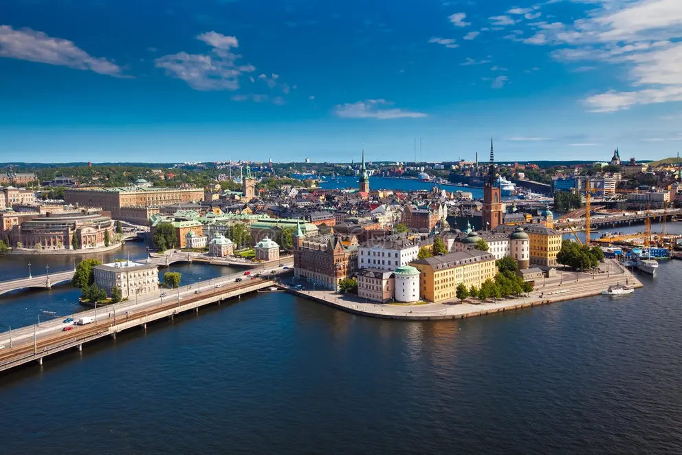 Aerial panorama of central Stockholm with Riddarholmen/Gamla Stan islands, bridges, and waterfront under a blue sky—city snapshot for Study in Sweden.
