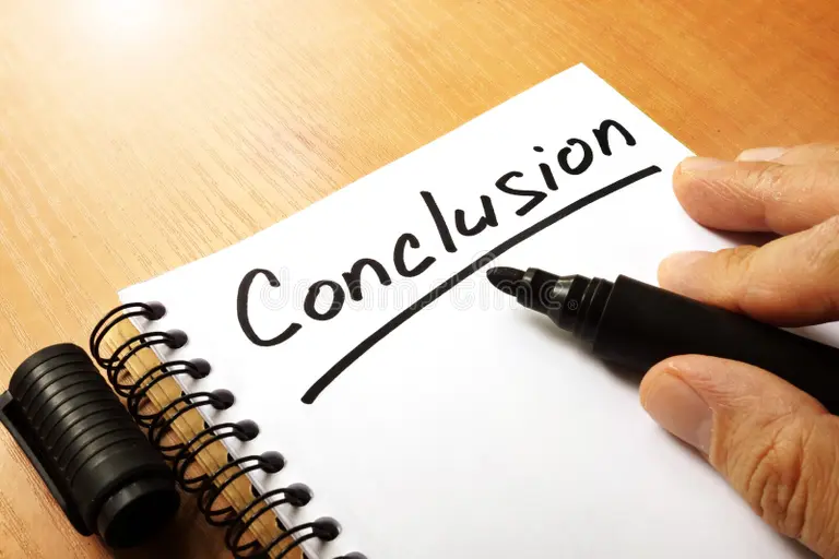Close-up of a hand writing the word “Conclusion” with a black marker on a spiral notebook—action checklist for Study in Sweden.