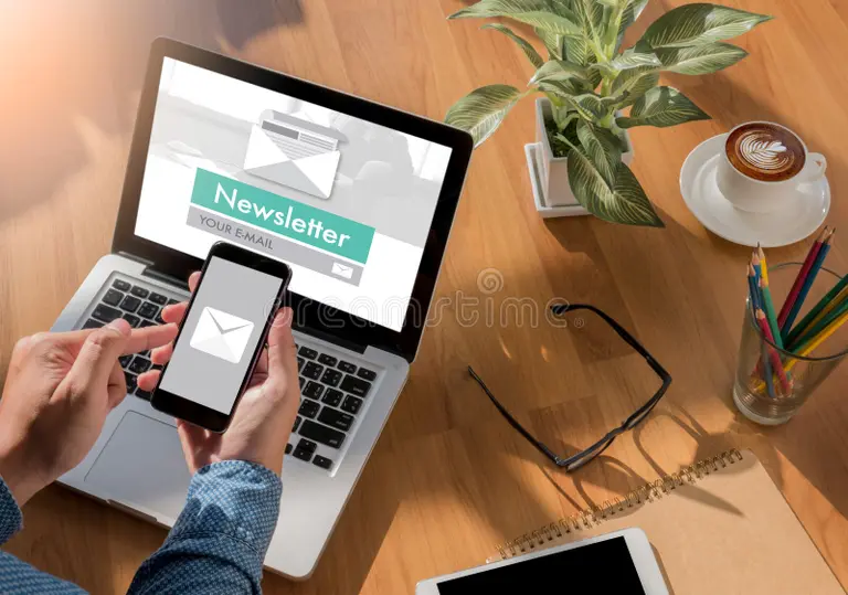 Hands using a phone with an email icon beside a laptop newsletter form—subscribe for Study in Singapore updates.