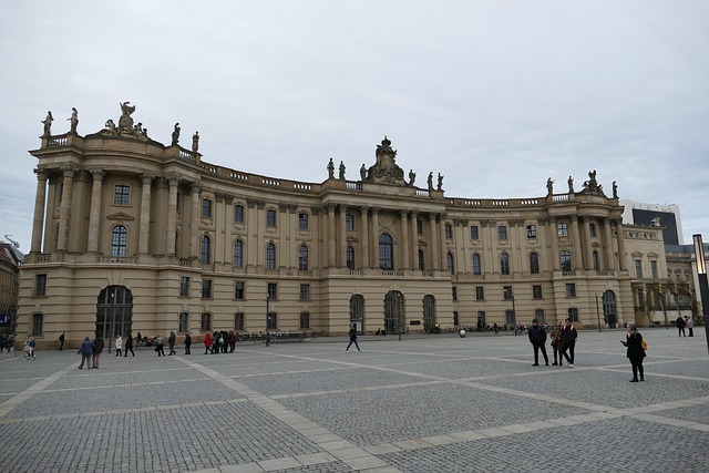 Humboldt University of Berlin in Germany, showcasing the grand neoclassical facade and historic Bebelplatz square under cloudy skies.