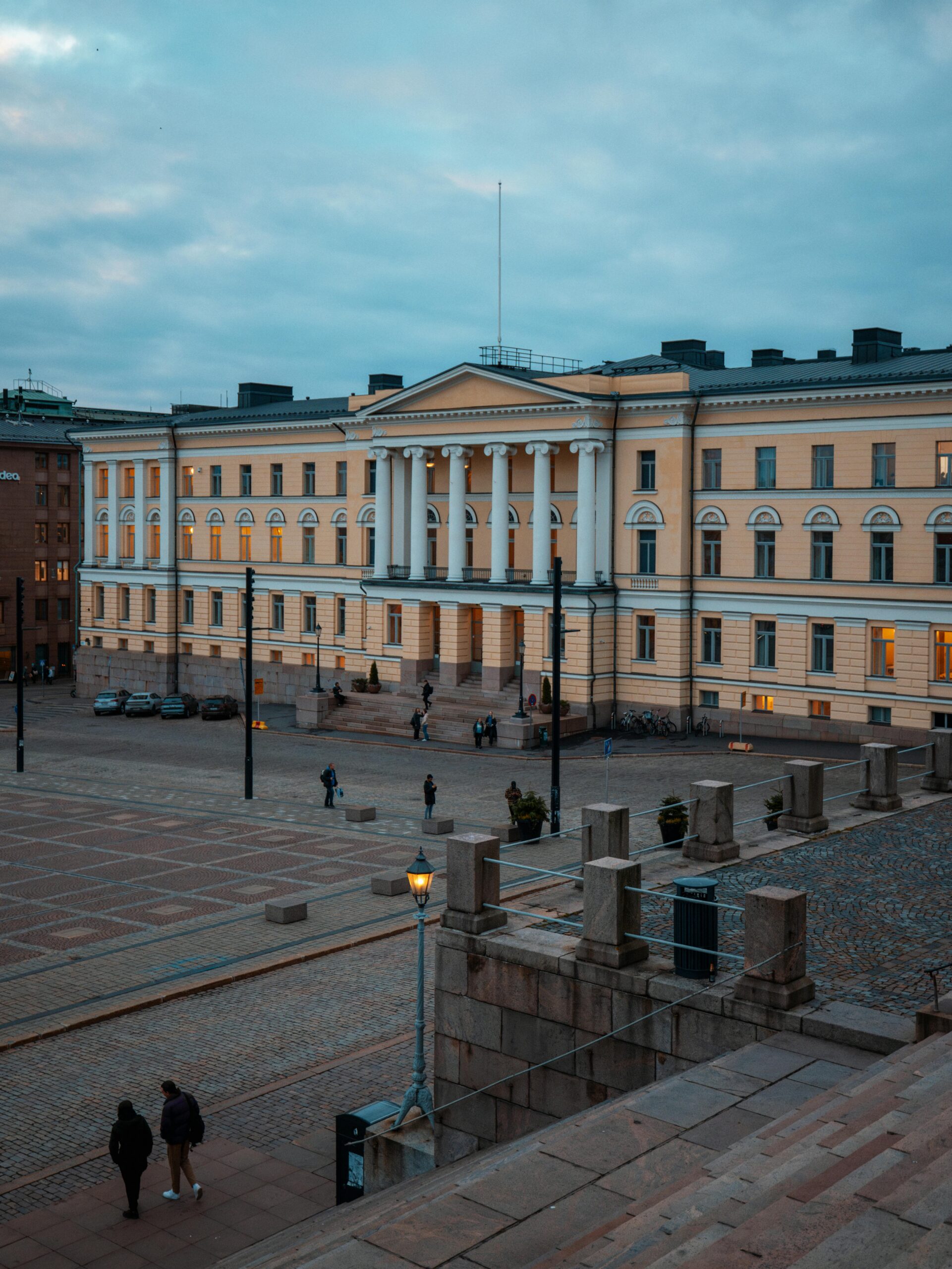 The University of Helsinki main building at dusk, showcasing neoclassical architecture and the calm evening ambiance in Finland.