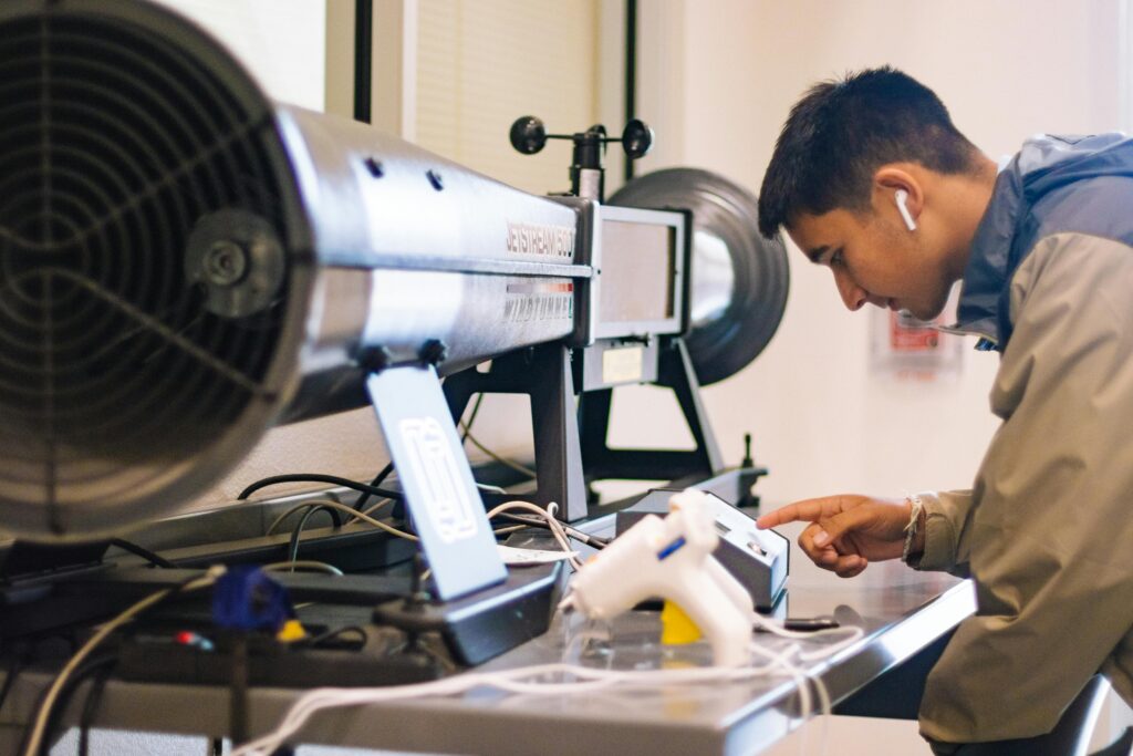 Engineering student experimenting with modern lab equipment in a UAE university, showcasing specialized technical courses.