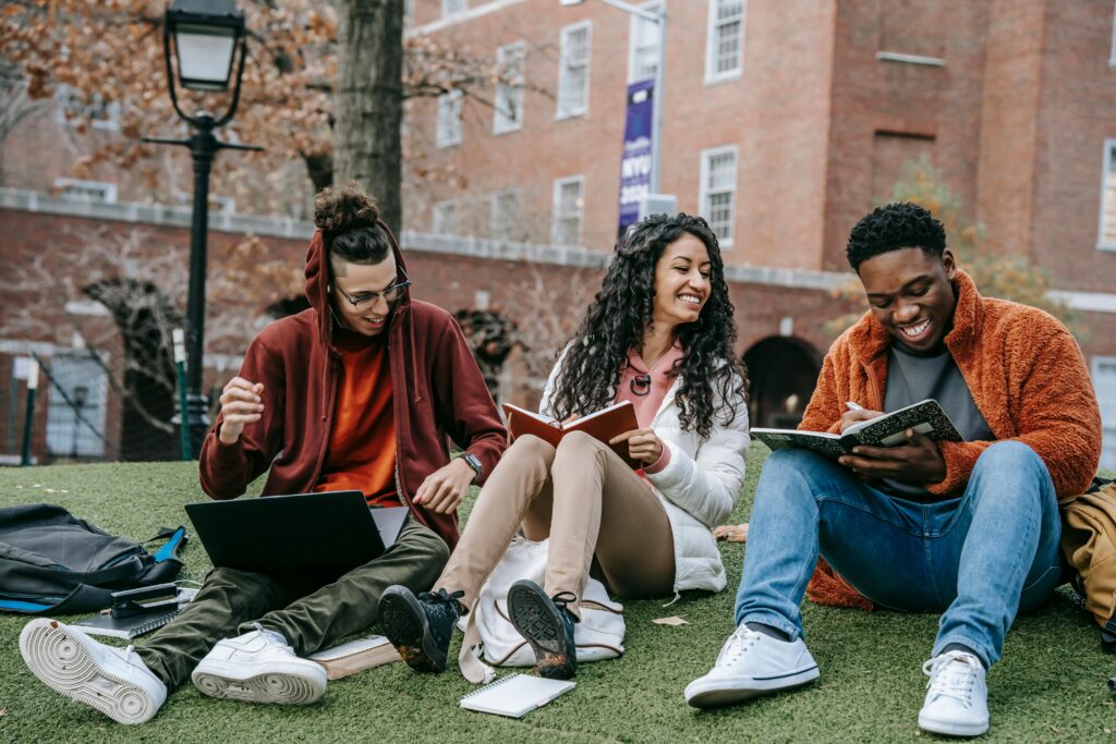 Happy international university students studying together outdoors in UAE campus