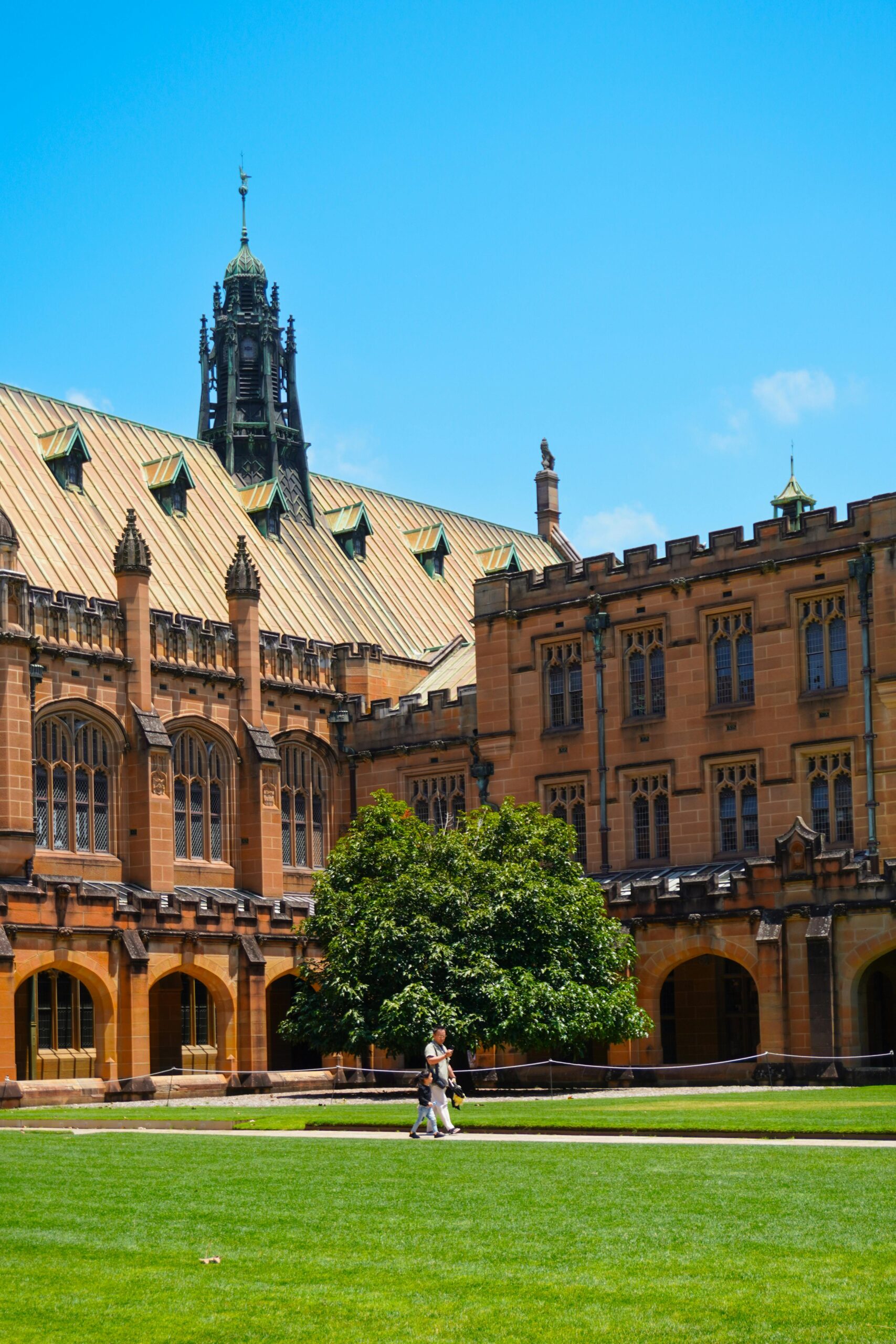 Beautiful Australian university campus with students walking across the lawn, representing quality education and study abroad opportunities in Australia.
