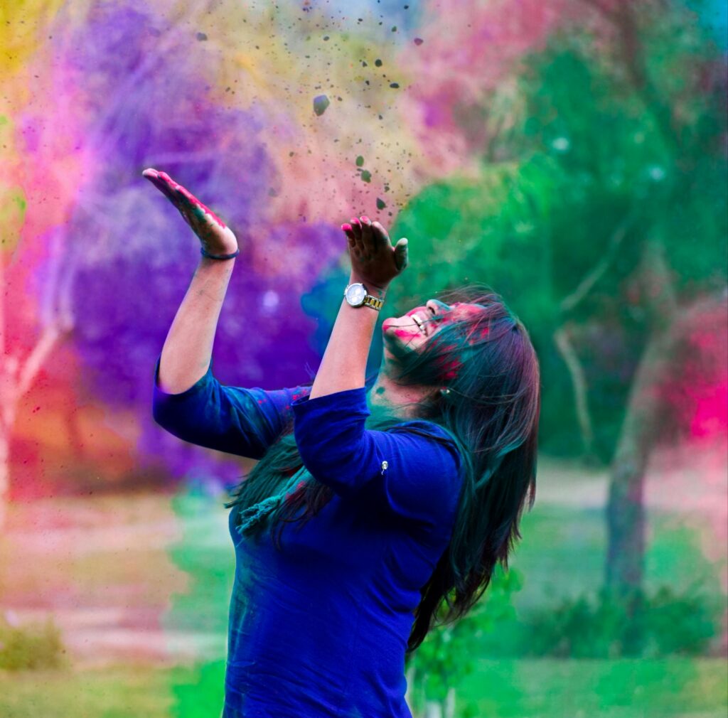 Student celebrating Holi with colorful powder in the air, representing India’s vibrant cultural festivals.
