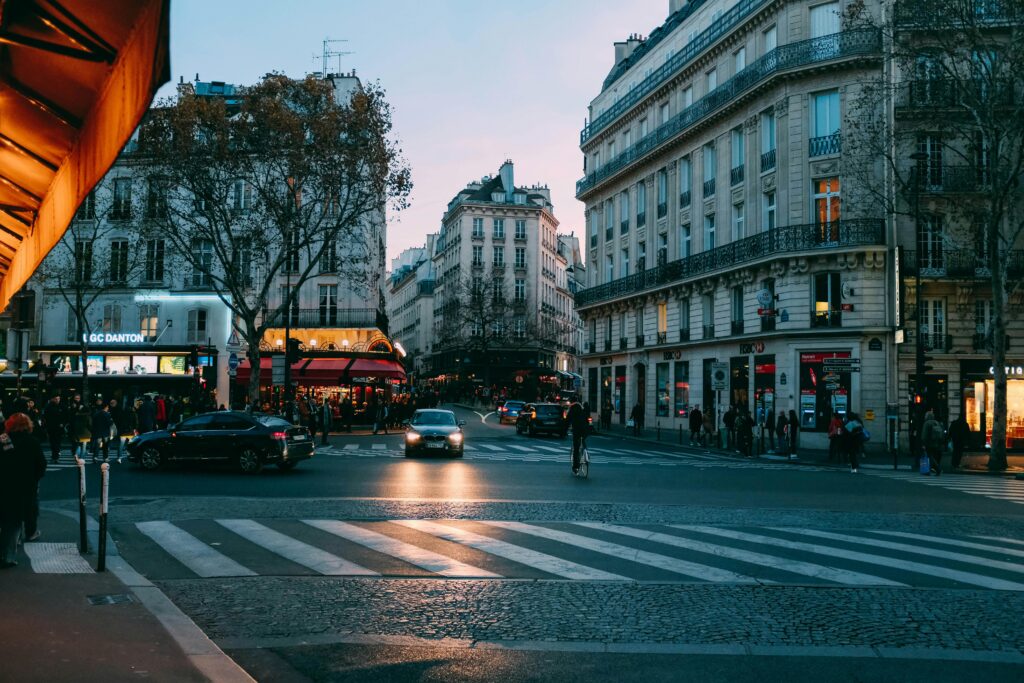 Evening street view in Paris with shops, cafes, and people, representing part-time jobs, internships, and work opportunities for students in France.