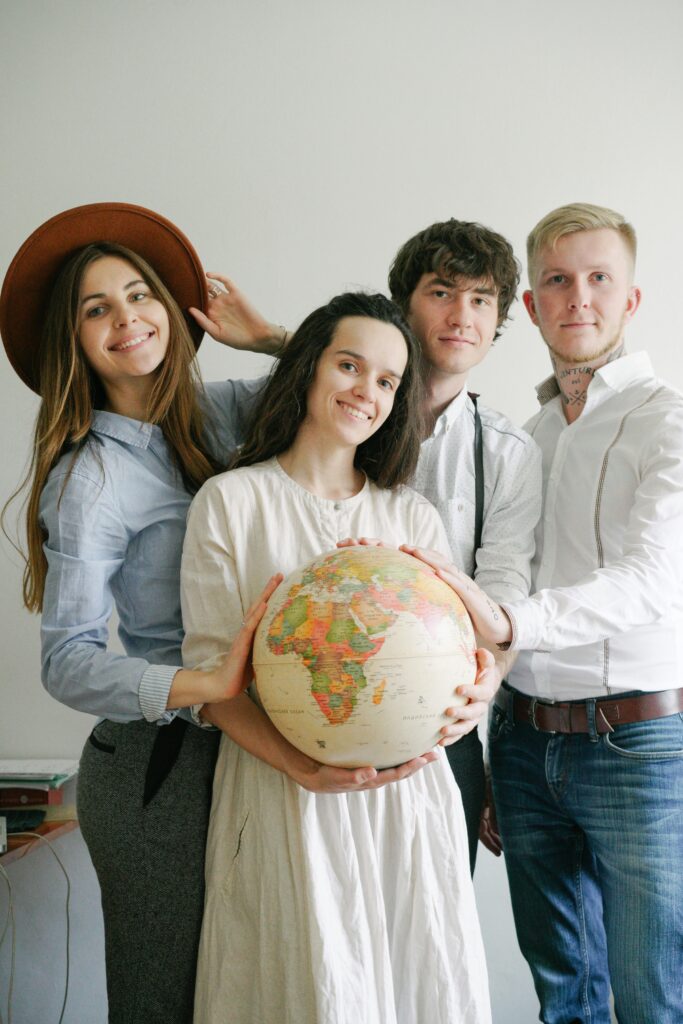 Group of international students holding a globe, representing global education and study abroad opportunities.