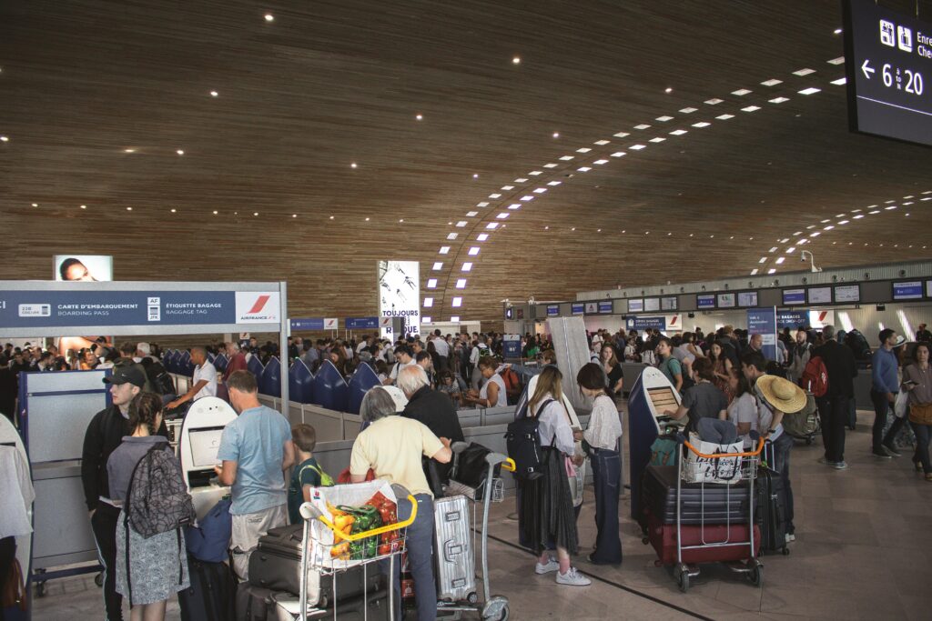 Crowded airport terminal in France with students and travelers completing arrival formalities