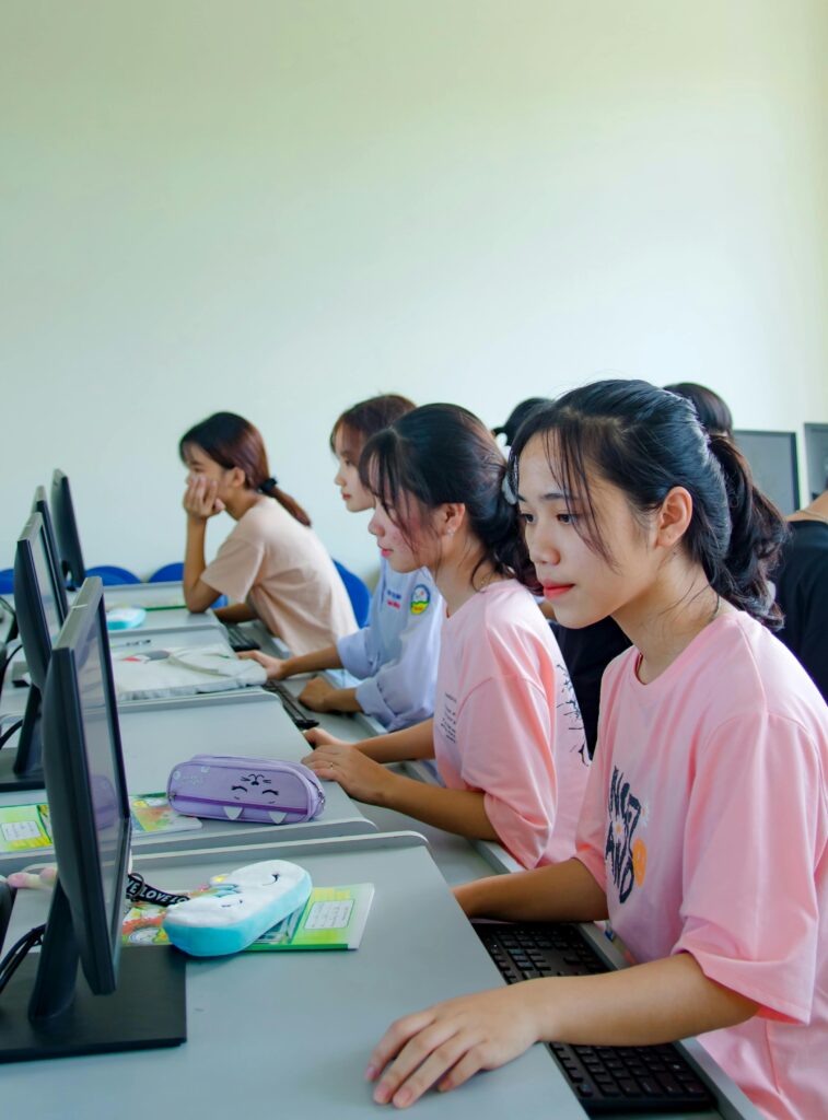 Students working on computers in a modern classroom, representing academic strengths, advanced programs, and learning advantages offered in China.
