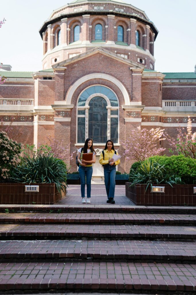Two international students walking on a university campus, representing tuition fees and scholarship opportunities for studying in Finland.