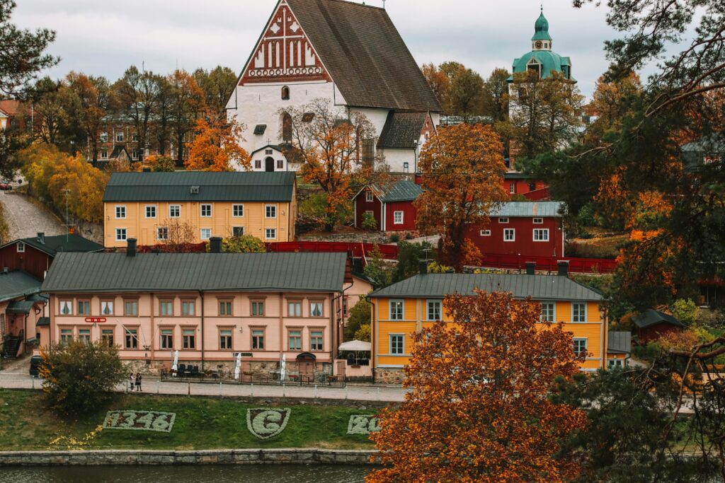 Colorful traditional wooden houses and Porvoo Cathedral during autumn in Porvoo, Finland