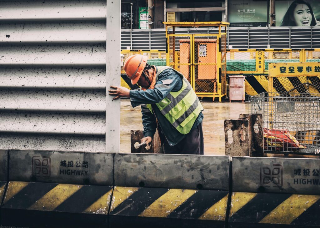 A construction worker in safety gear operating at an industrial site in China, symbolizing career opportunities, internships, and strong industry links for students and professionals.