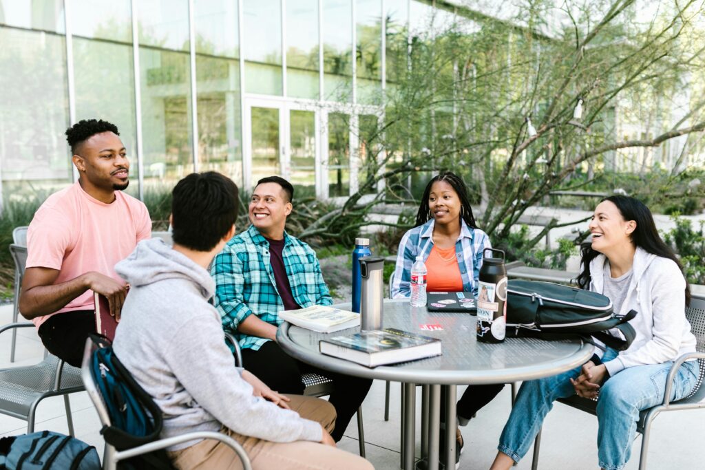 Group of international students talking and smiling outdoors on a university campus in Finland