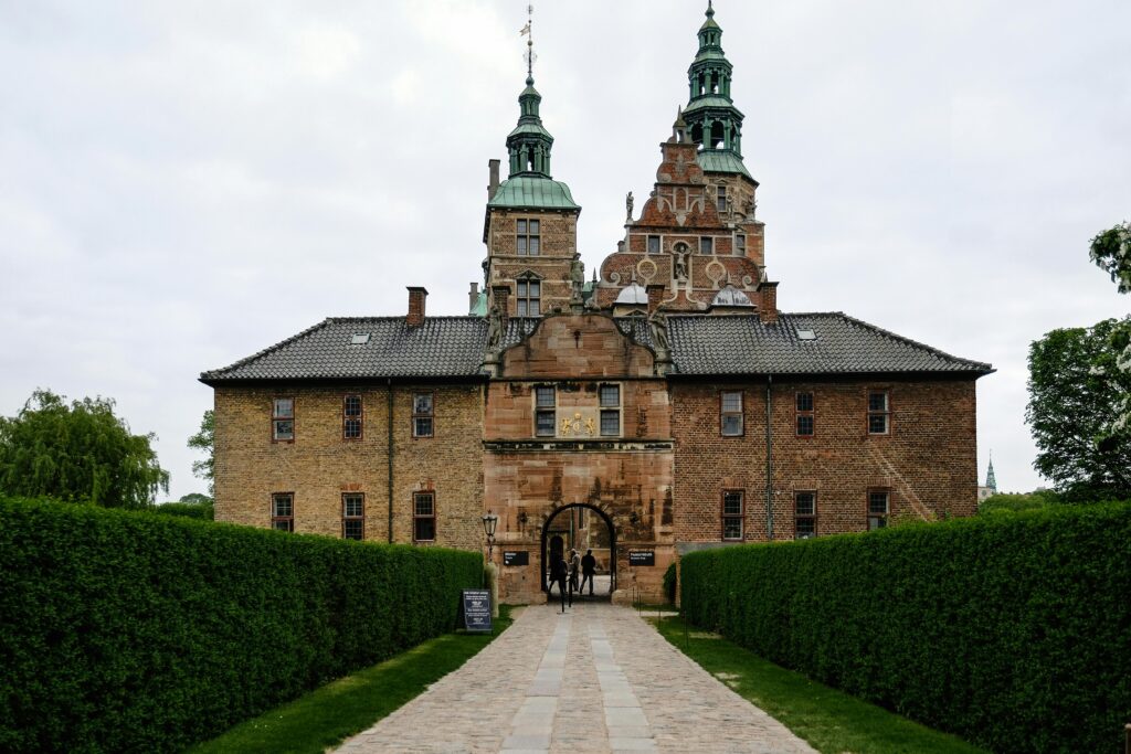 Historic Copenhagen castle entrance surrounded by greenery, symbolizing cultural heritage and student cultural experience in Denmark.