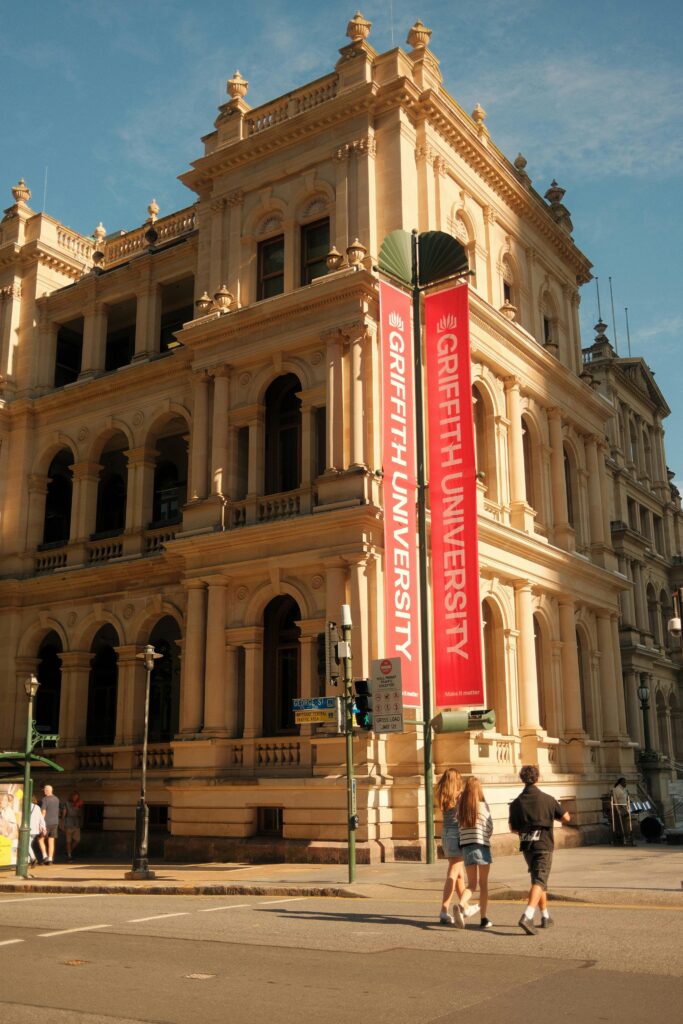 Griffith University building in Australia with students walking nearby, representing study intakes and university application deadlines for 2025.