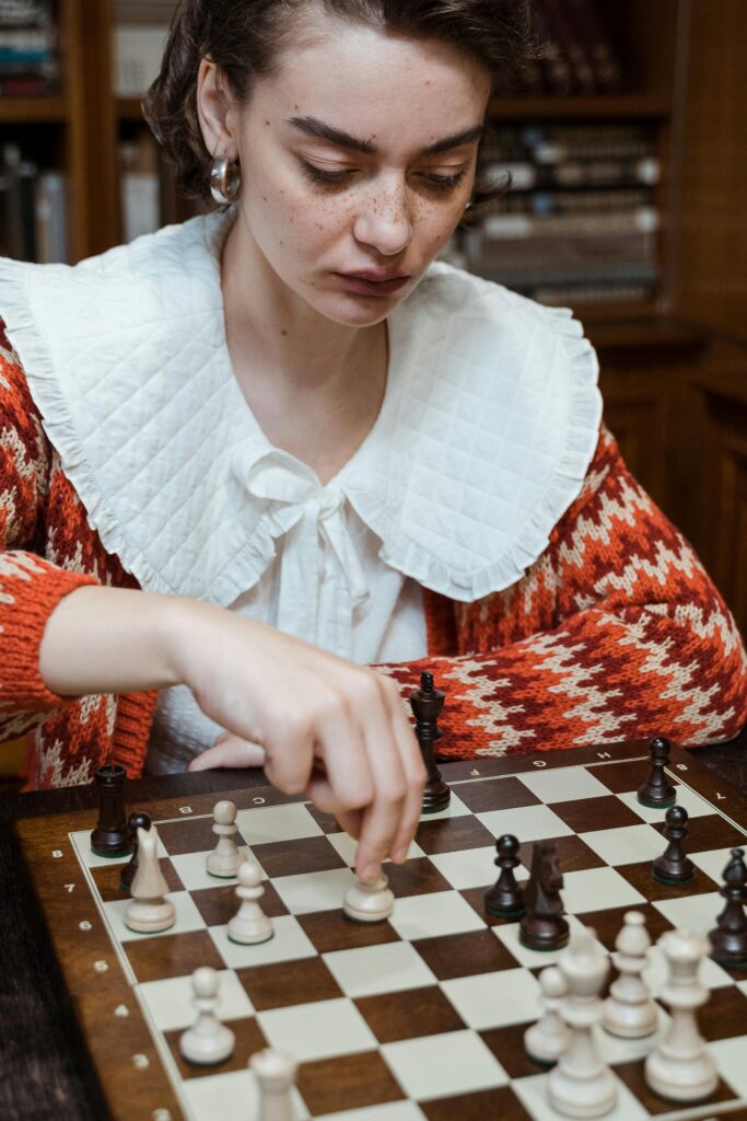 A thoughtful student playing chess, symbolizing strategic decision-making and balancing benefits and challenges of studying in Australia.