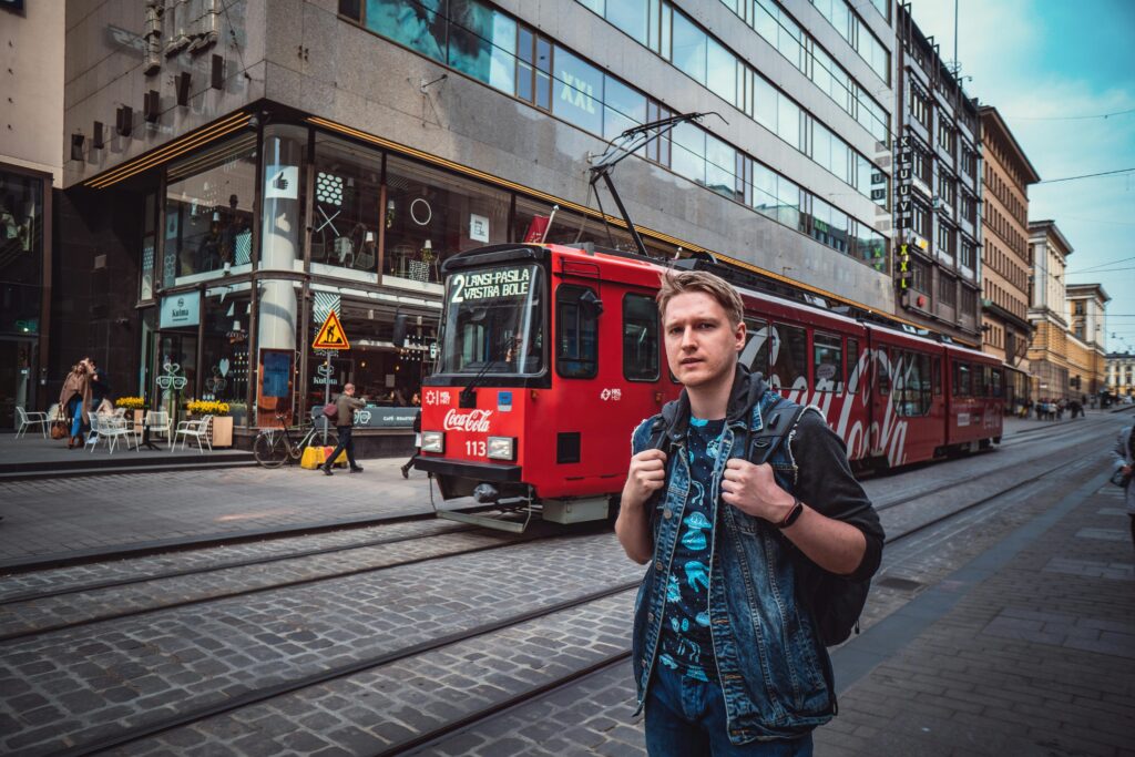 Student standing near tram in Helsinki city center — Best Cities for Study in Finland
