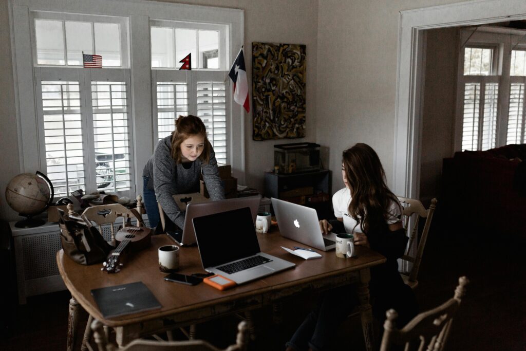 Students working part-time on laptops in a shared workspace, representing part-time work opportunities for students in Germany