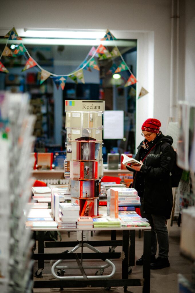 Student reading books in a library while subscribing for Study in Germany updates
