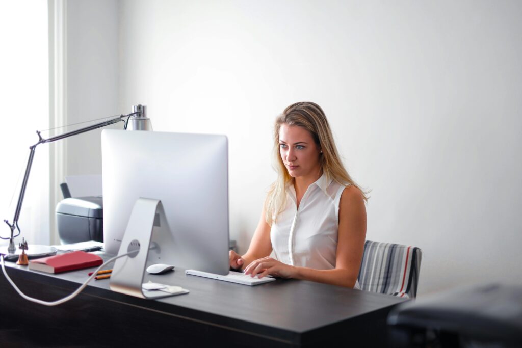 A student working on a desktop computer while researching study abroad opportunities and preparing for international education.