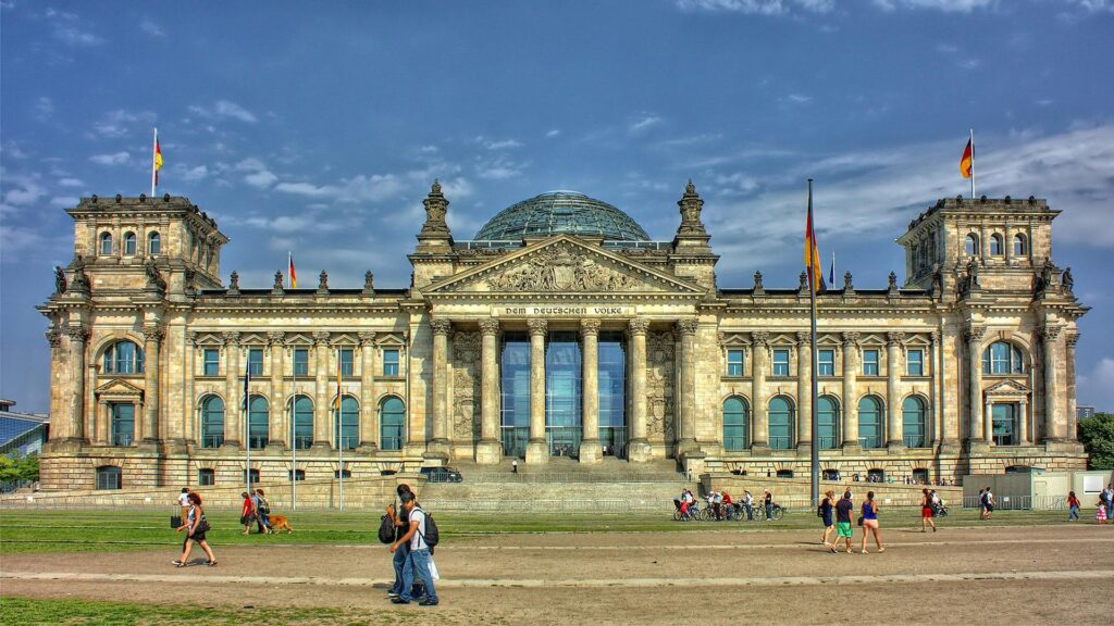 Students and visitors walking near the Reichstag building in Berlin, representing the admission timeline and academic planning for German universities.