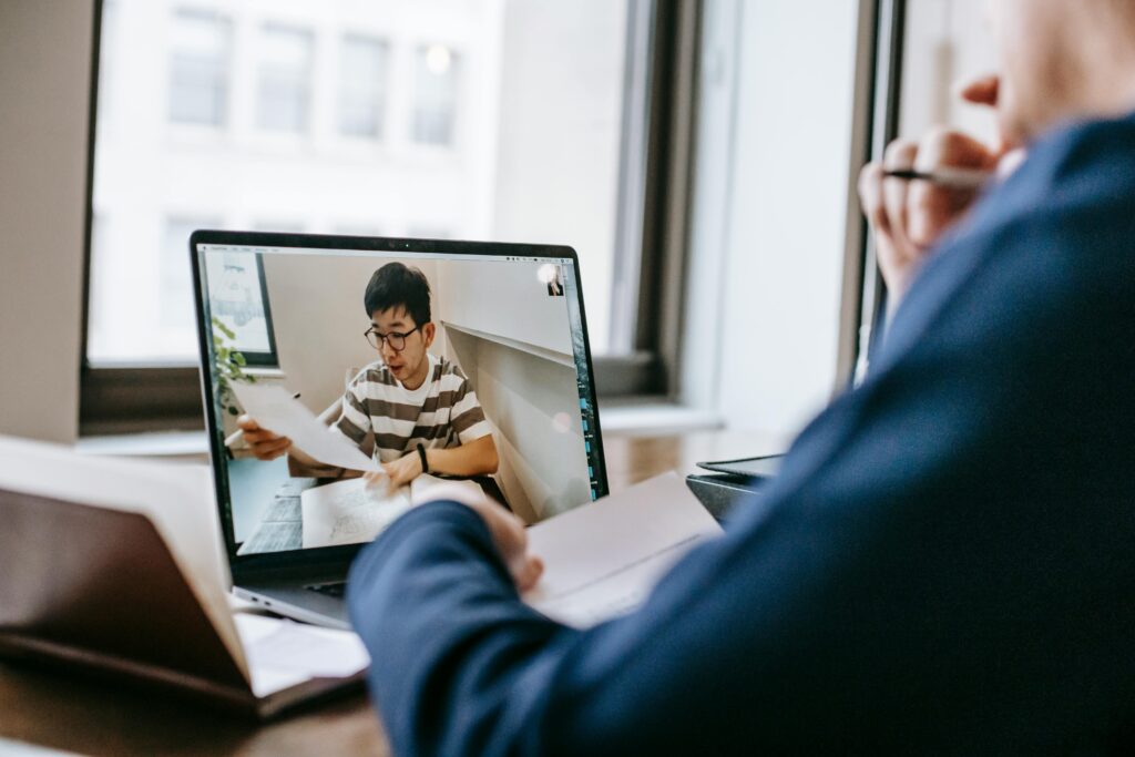 Student attending an online document review meeting on a laptop, representing the document checklist required for education in Germany.