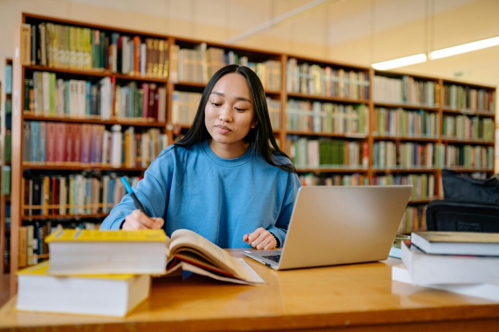 Student studying in a library representing popular academic courses in Ireland