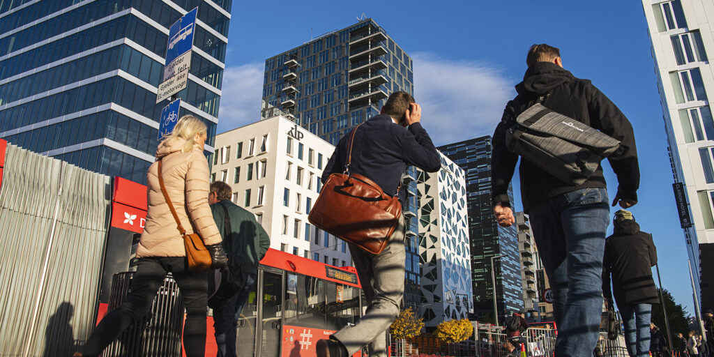 Work opportunities and PR pathways in Norway for international students, showing professionals in Oslo city business district
