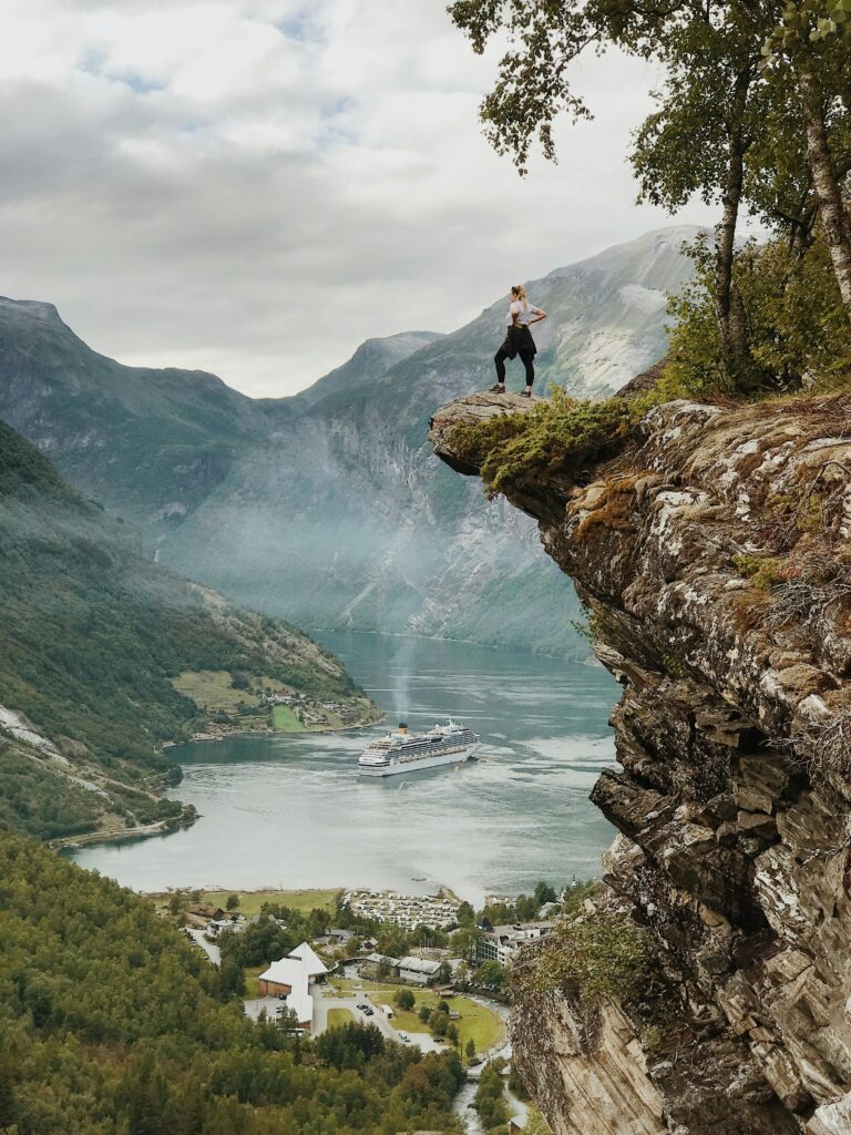 Student exploring Geiranger fjord landscape in Norway during study abroad