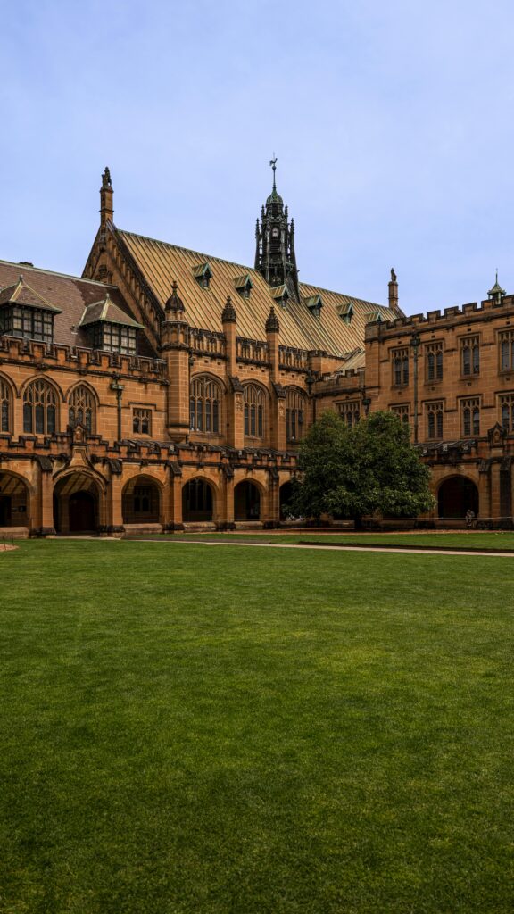Historic architecture of the University of Sydney quadrangle showcasing sandstone buildings and green lawn