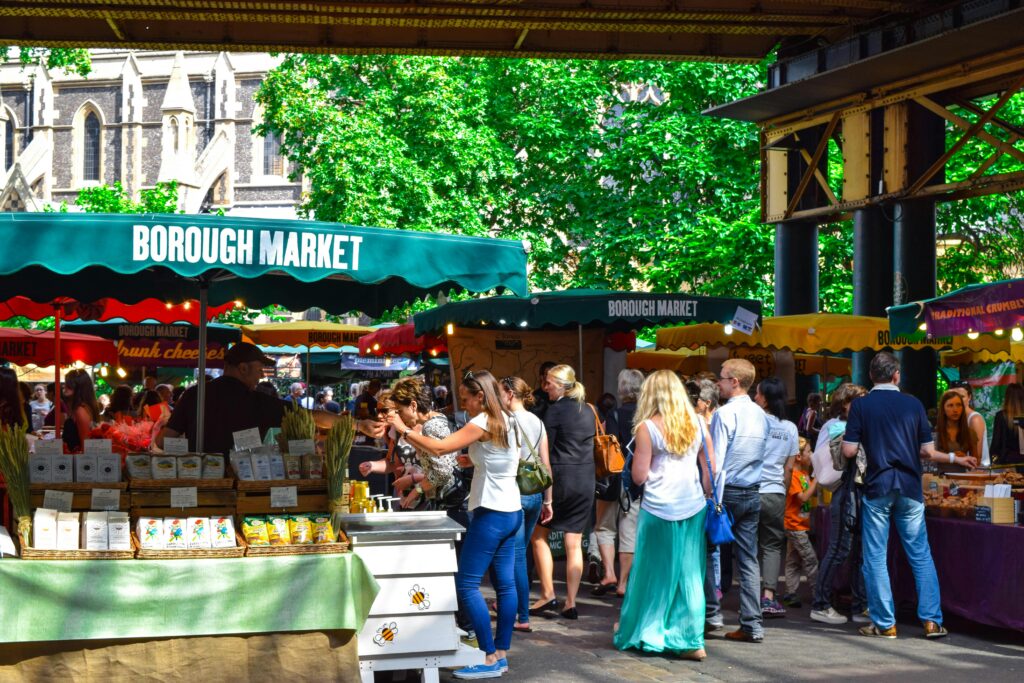 Crowded Borough Market in London showing daily food and grocery costs for international students living in the UK