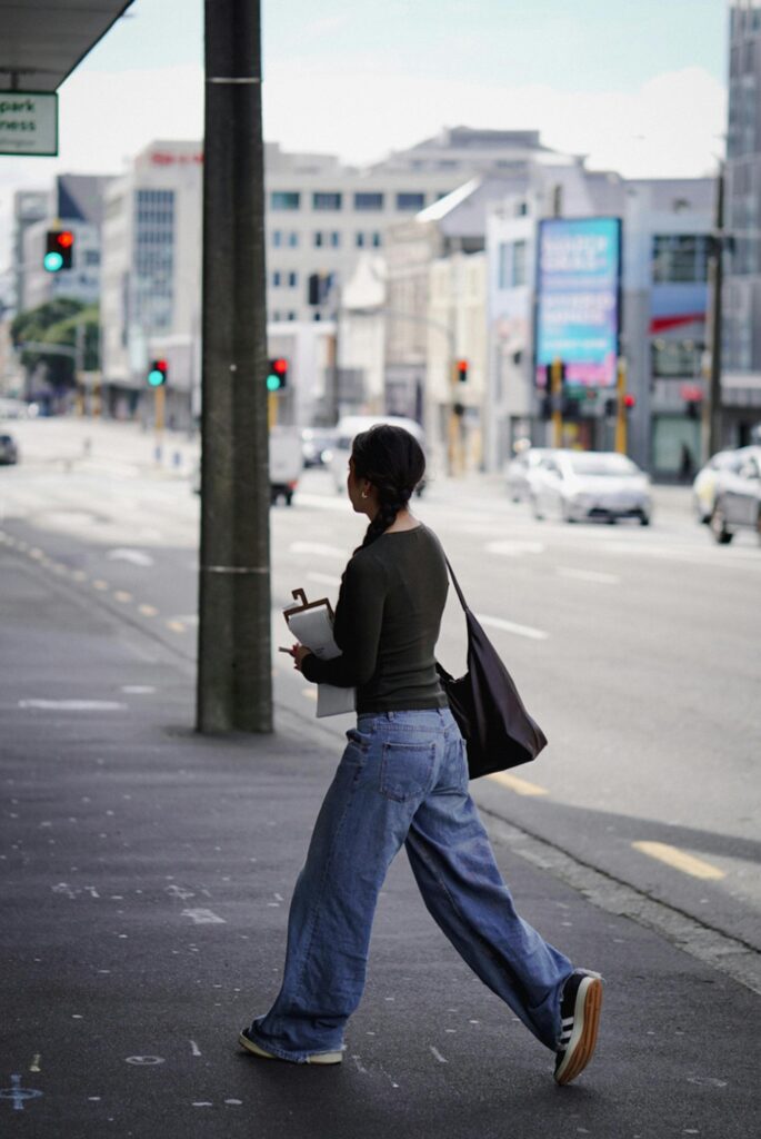 International student walking in an urban area representing eligibility criteria to study in New Zealand for higher education