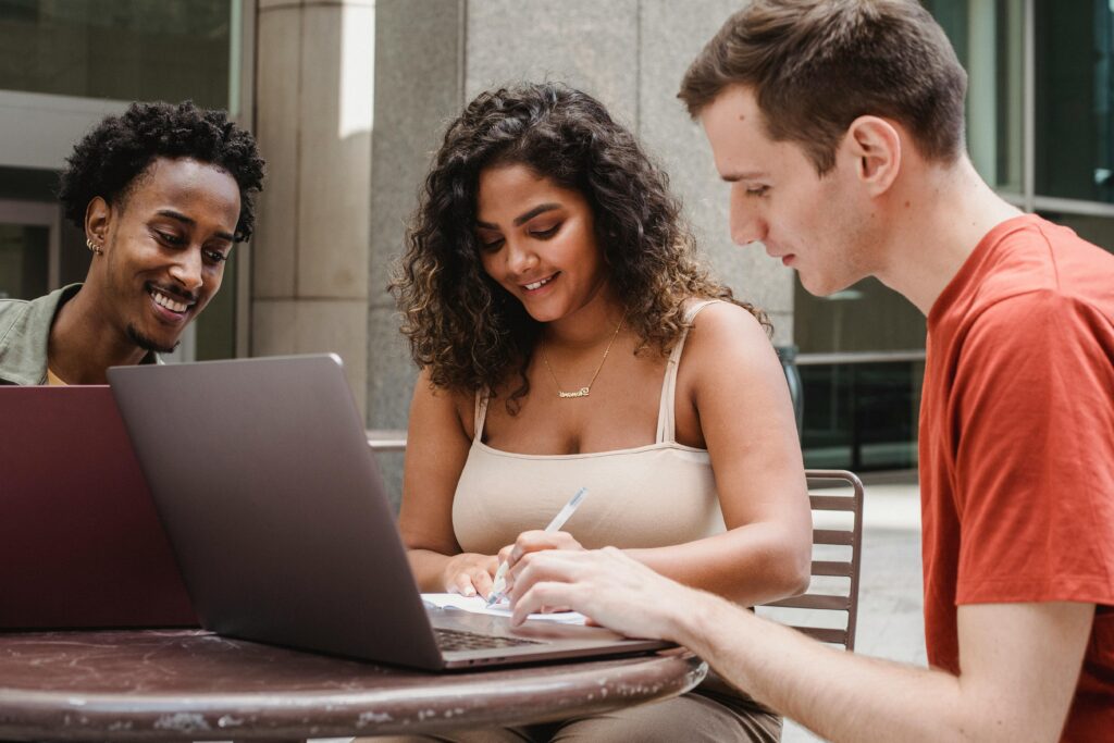 Students reviewing a study abroad checklist together on a laptop