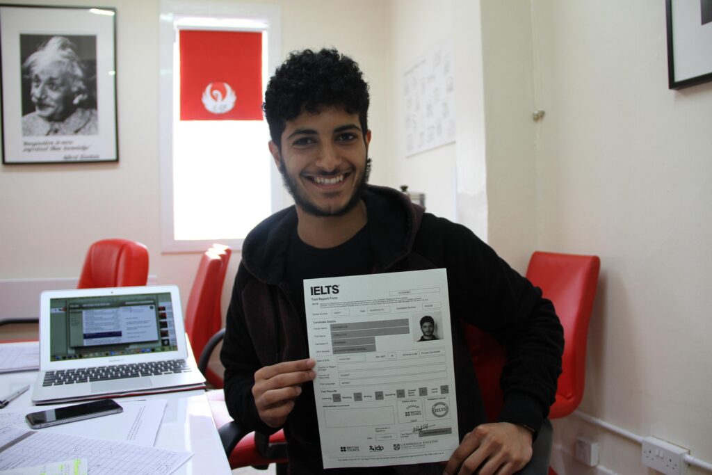 Student holding IELTS test report while preparing for study abroad entrance exam