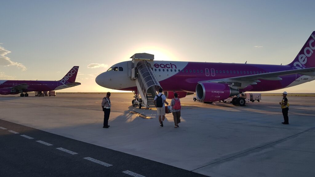 Students boarding an airplane at the airport before flying abroad for international studies.