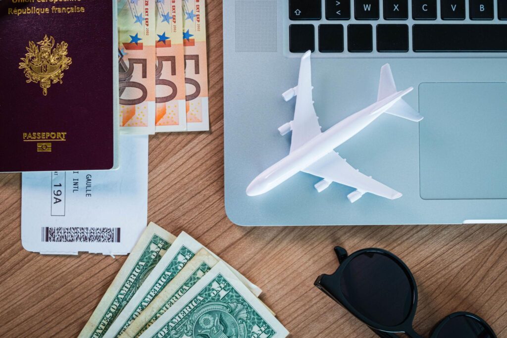 Student calculating budget and expenses to apply universities abroad with laptop and calculator