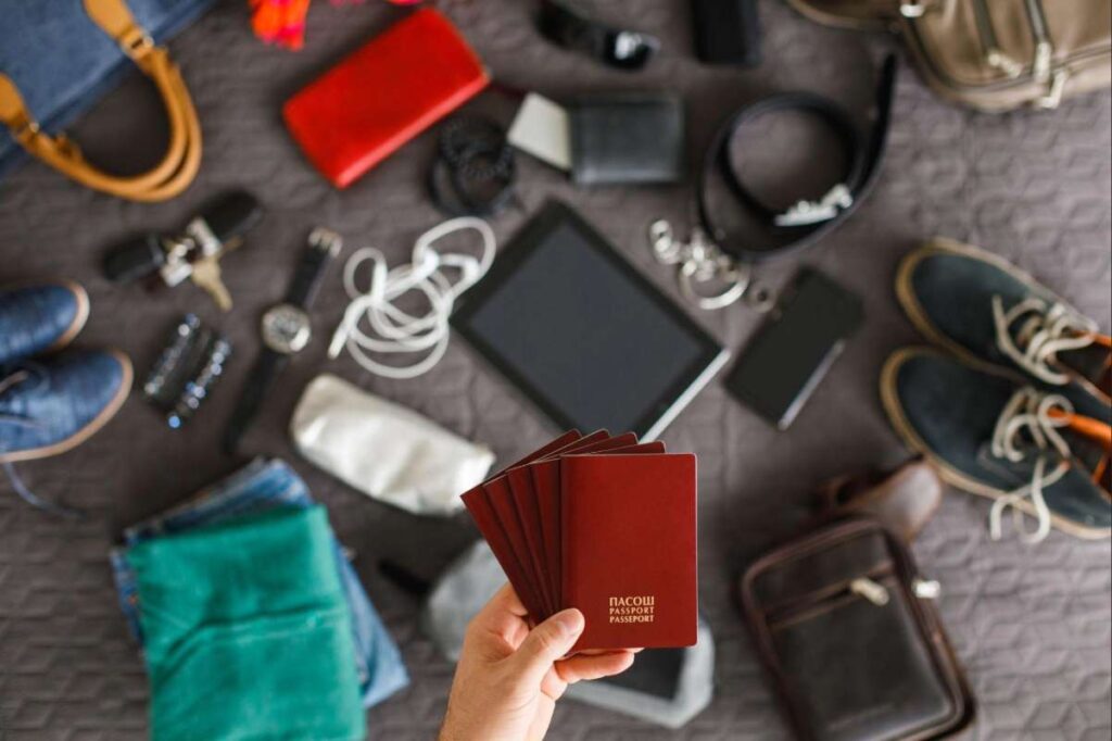 Study Abroad Packing List essentials with passport, gadgets, clothes and travel items before international travel
