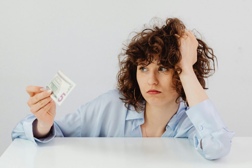 study abroad without money student worried about finances holding small amount of cash