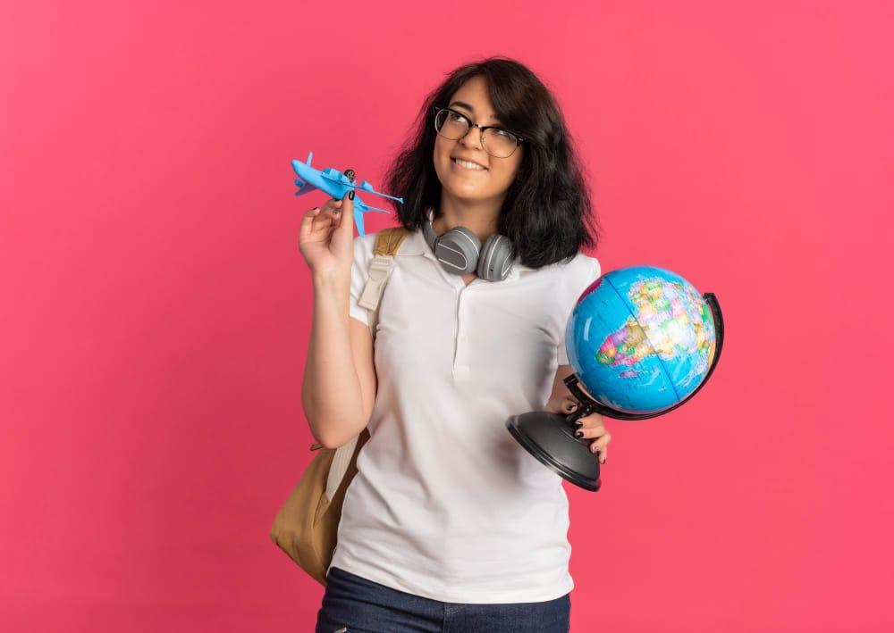 International student holding globe and airplane thinking about opportunities and challenges after student visa expiry