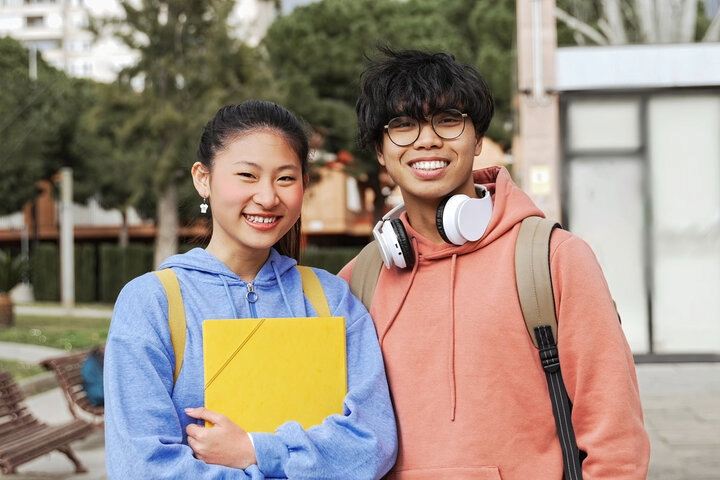 Study in China international students smiling on a modern university campus, representing student life and higher education in China.
