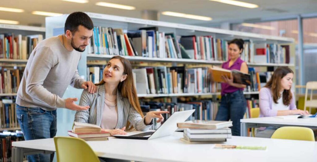 Study in Australia students studying together in a modern university library with academic guidance